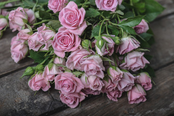 Bouquet of pink roses on vintage wooden floor