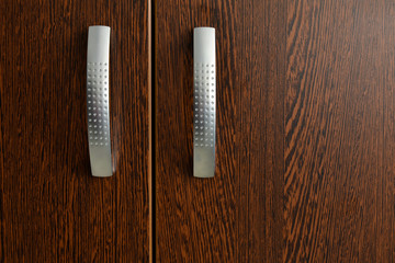 Wood wardrobe with aluminum handles in natural light