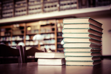 piles of books in library hall (Shallow depth of field)