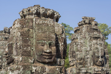 Fototapeta na wymiar Stone head on towers of Bayon temple in Angkor Thom, Cambodia
