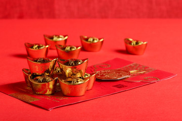 Chinese red pockets and ancient Chinese golden ingots