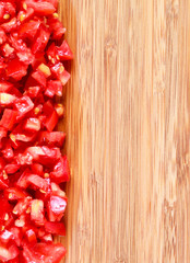 fresh diced / chopped red tomatoes on cutting board with copy space