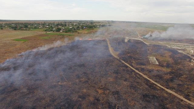 Dry Field Burning Near Settlement