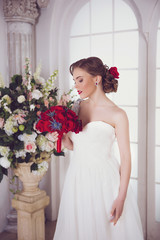 Portrait of Young Beautiful Attractive Bride with Flowers. White Dress and Wedding Decorations. Vintage Toning