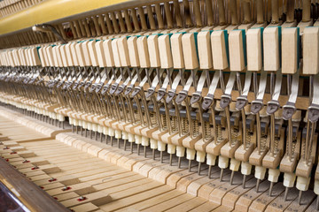 Action mechanics of an upright piano