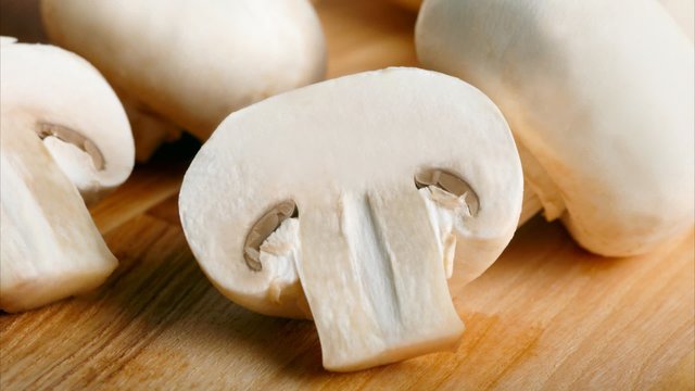 Champignon on wooden background