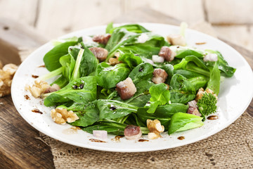 Feldsalat angemacht mit Speckwürfeln und Walnüssen