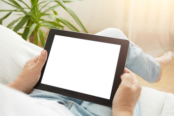 Close up to view mature woman's hands hold black tablet with empty screen, female hands holding touch screen tablet pc with blanc screen sitting on couch