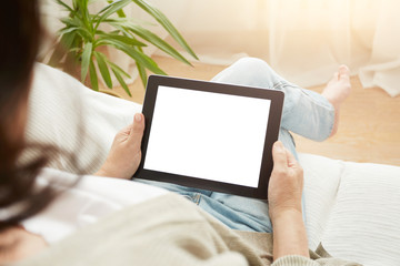 Close up to view mature woman's hands hold black tablet with empty screen, female hands holding touch screen tablet pc with blanc screen sitting on couch