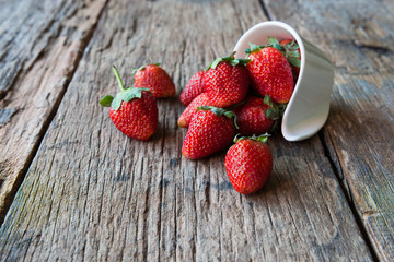 Strawberry over Wooden Background.