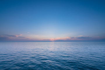 Fototapeta na wymiar Beautiful sunset with blue sea and sky peaceful background long