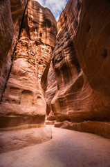 Elephant carved in the rock. Narrow slot-canyon that serves as the entrance passage to the hidden city of Petra, Jordan. UNESCO World Heritage Site. 