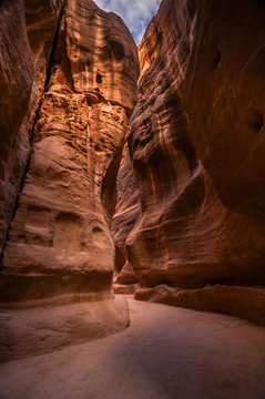 Narrow slot-canyon that serves as the entrance passage to the hidden city of Petra, Jordan. UNESCO World Heritage Site. Elephant carved in the rock