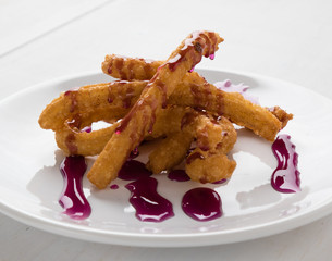 churros on plate with fruit syrup