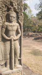 Fototapeta na wymiar Soldier with a massive club guarding the entrance to the Banteay Kdei Temple built by Jayavarman VII in the 12th Century, Cambodia.