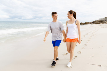 Runners. Young couple running on beach