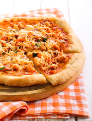 Salmon and herb pizza on board