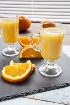 Natural and fresh orange juice in glass cup with fresh orange