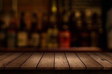 wooden table with a view of blurred beverages bar backdrop