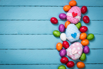 easter concept with colorful handmade eggs and rabbit on wooden table