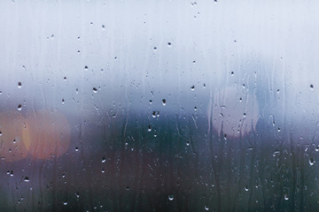 Drops on glass, rain behind a window