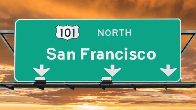 San Francisco 101 freeway sign with sunset time lapse sky.