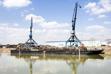 Fototapeta na wymiar Harbor cranes and scrap metal