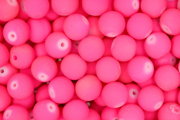 Small pink beads background. Texture.