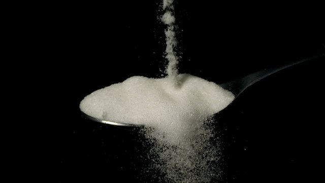 Sugar Crystals Refined Falling on Spoon Super Slow Motion