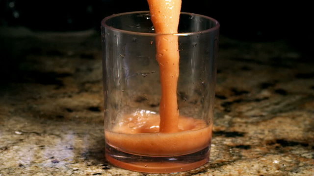 Fruit and Vegetable Juice Poured into Glass in Super Slow Motion.