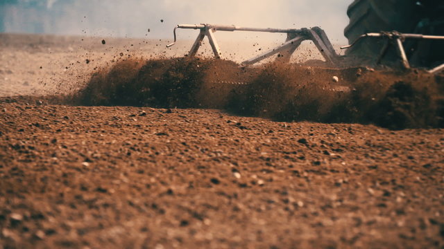 Tractor plowing field at sunset