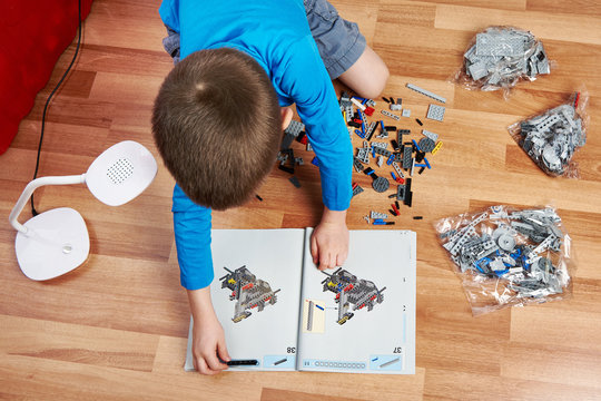 Little boy collects children's plastic building kit