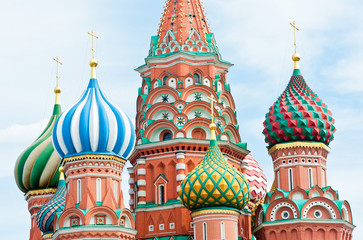 Fototapeta na wymiar Domes of Saint Basil's Cathedral against blue sky with white clouds, Red square, Moscow, Russia