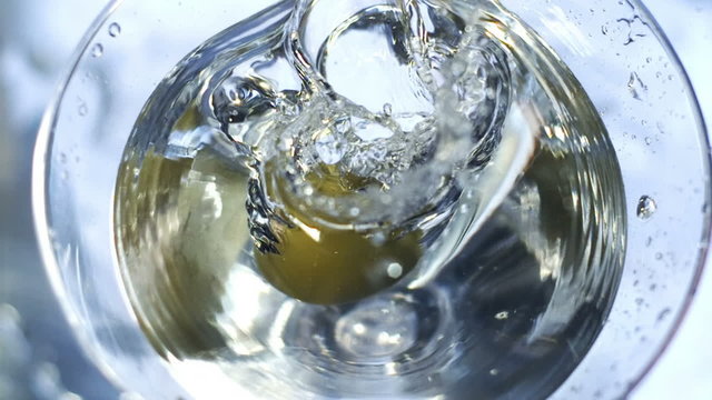 Martini With Olive Splashing Top View In Super Slow Motion