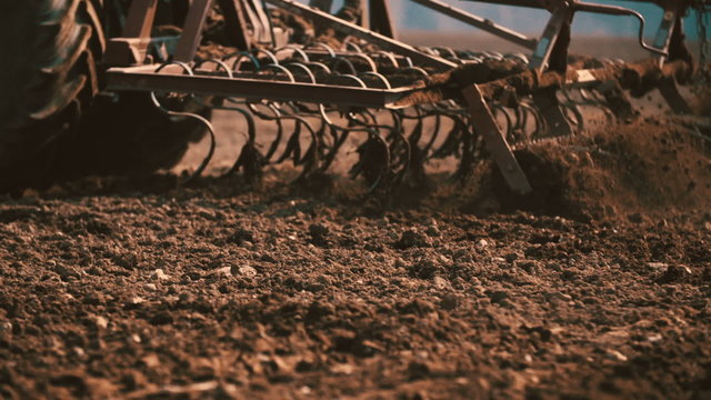 Agricultural tractor sowing and cultivating field