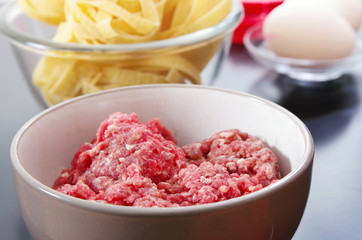 raw mince, pasta and eggs are ready to cook