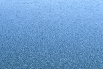 Ripples on the water. Background horizontal.
Blue water of spring river. The water reflects the blue sky. Light ripples.