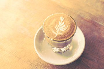glass of latte coffee on wooden table