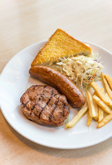 Grilled steak, French fries and vegetables