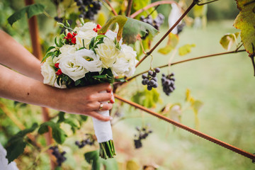 Fototapeta premium beautiful wedding bouquet with peony, roses, orchids, and green leaves.