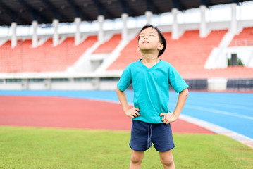 Boy stand on the football field.