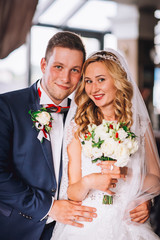 Happy bride and groom in royal vintage interior of restaurant