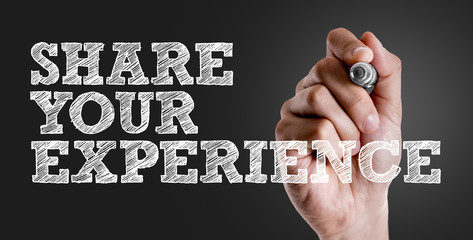 Hand writing the text: Share Your Experience