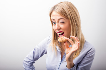 Woman eating chocolate chip cookie