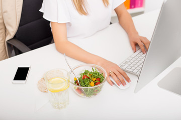 Woman in the office with healthy lunch