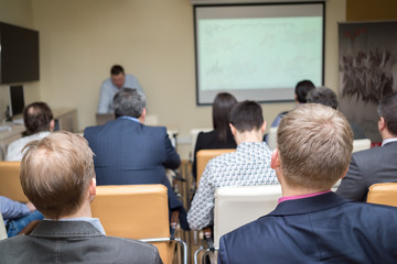 Speaker at business workshop and presentation. Audience at the conference room.