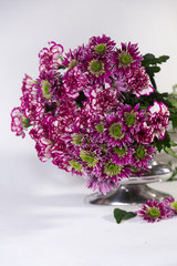 Bouquet of carnations and chrysanthemums in a steel vase