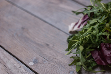 fresh rocket salad on wooden table