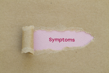 Symptoms word written under torn paper.