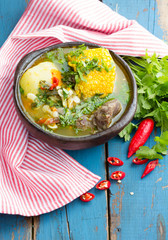 Latin american food. Cazuela - traditional chilean soup served in clay plate from pomaire